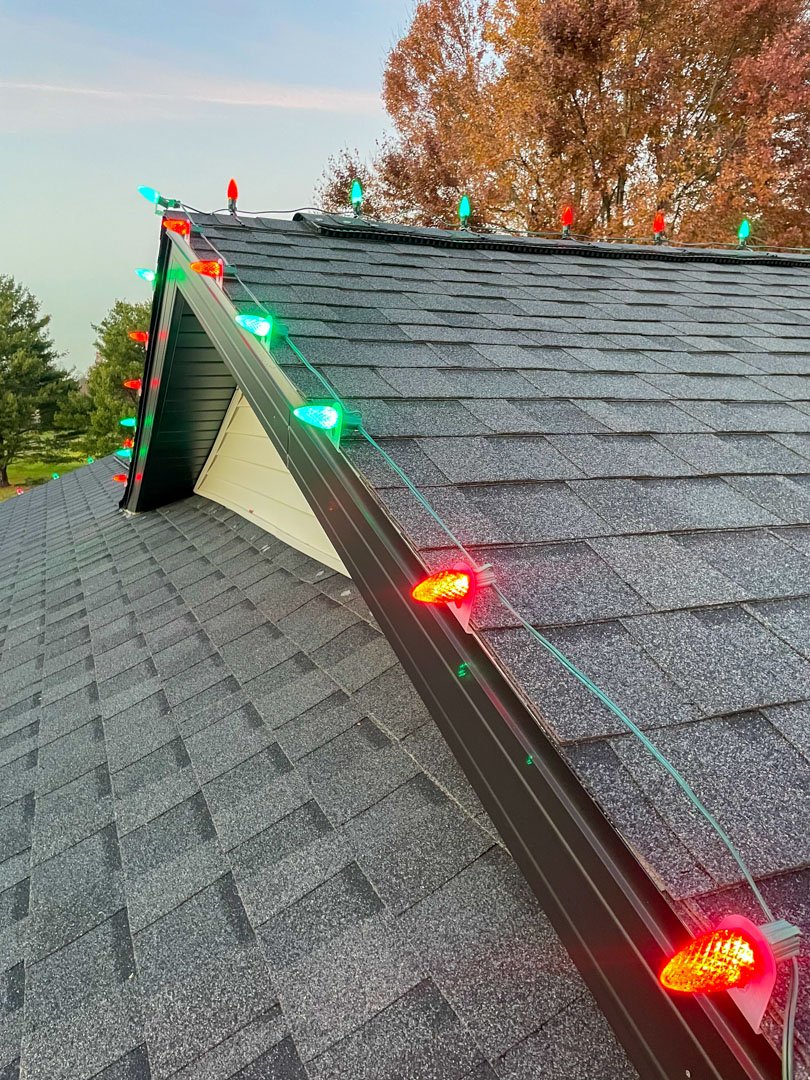 Close-up of red and green bulbs following a roofline